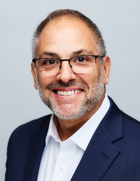 David Lewis, National Managing Director of HR & Organizational Effectiveness Consulting Practice at Gallagher seen posing for a photo with a bright smile on his face